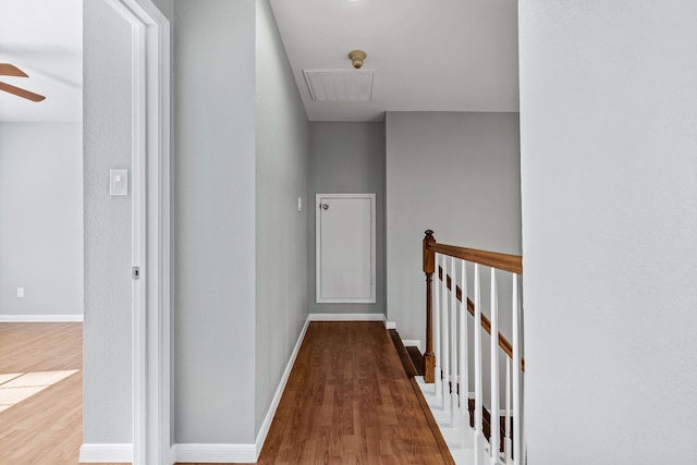 corridor with hardwood / wood-style flooring