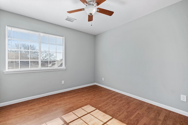 empty room with ceiling fan and wood-type flooring