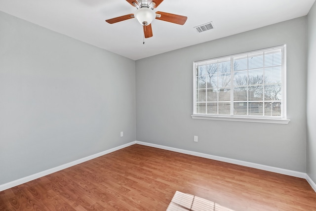 empty room with light wood-type flooring and ceiling fan