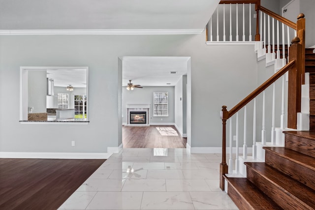 entrance foyer featuring crown molding and ceiling fan