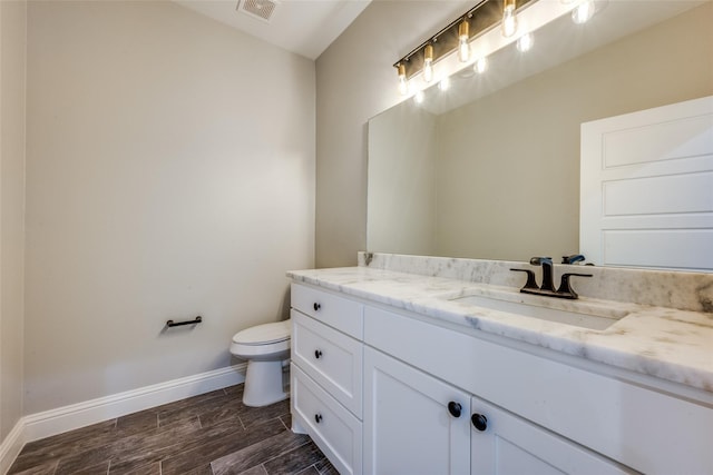 bathroom with toilet and vanity