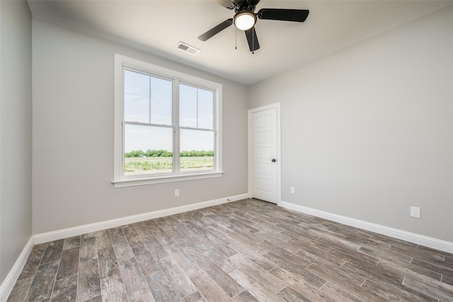 unfurnished room with hardwood / wood-style flooring and ceiling fan