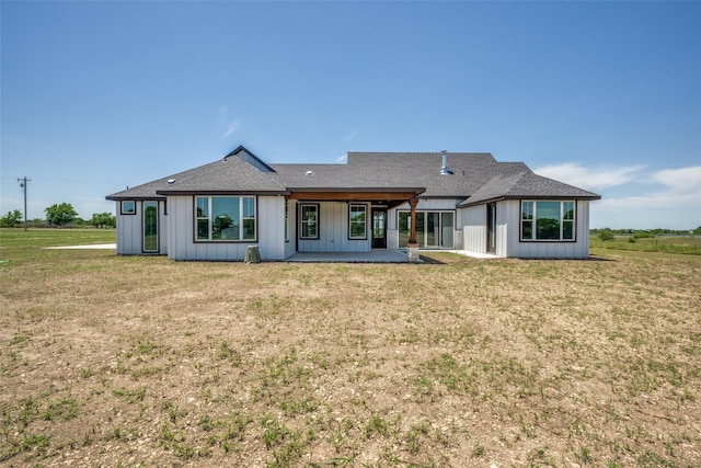 back of property featuring a lawn and a patio