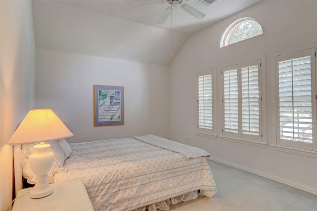 carpeted bedroom featuring vaulted ceiling and ceiling fan