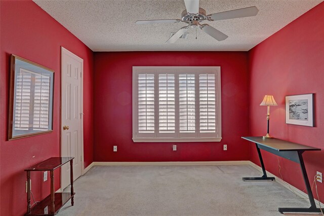 misc room featuring ceiling fan, light colored carpet, and a textured ceiling