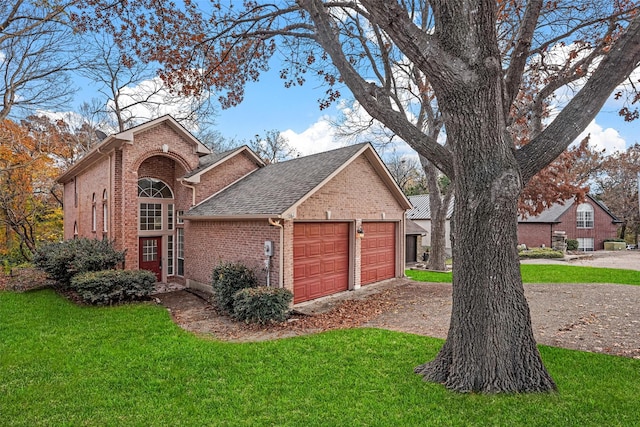 view of front facade with a front yard and a garage