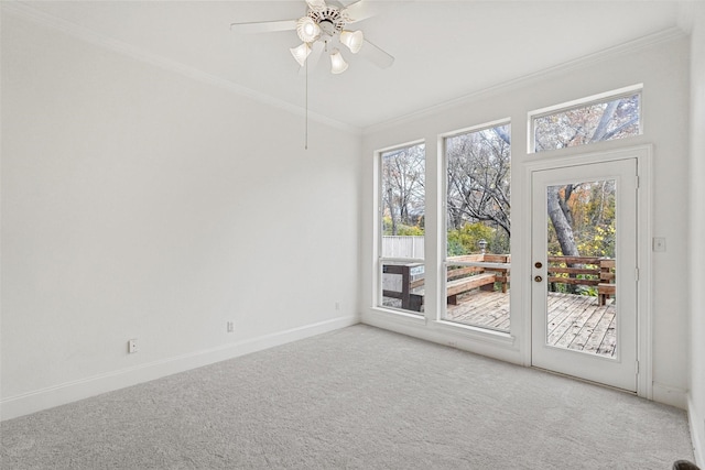 carpeted empty room featuring ceiling fan and crown molding