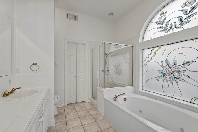 full bathroom with tile patterned flooring, shower with separate bathtub, vanity, and toilet