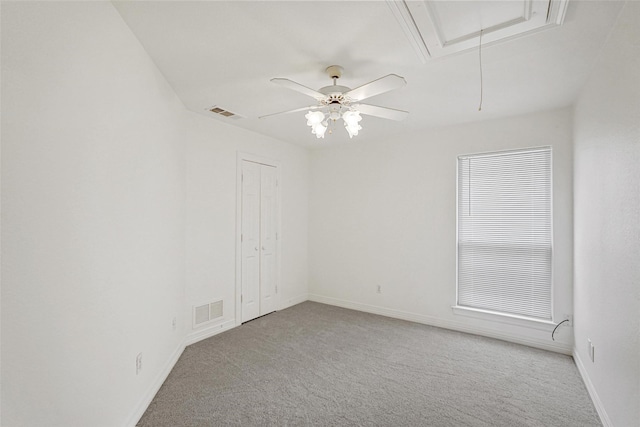 carpeted spare room with ceiling fan