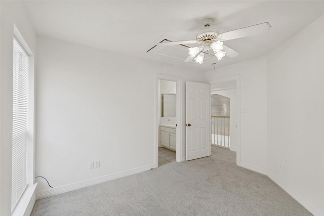 unfurnished bedroom with light carpet, connected bathroom, and ceiling fan