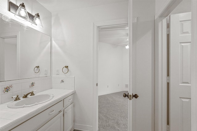 bathroom featuring vanity and backsplash