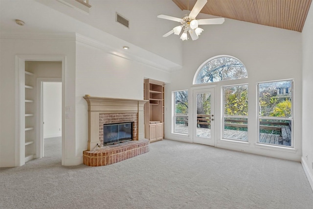 unfurnished living room with ceiling fan, built in features, a fireplace, and high vaulted ceiling