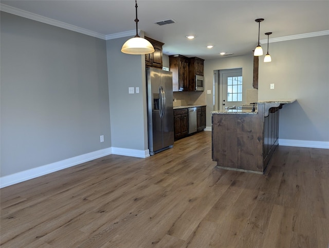 kitchen with kitchen peninsula, tasteful backsplash, dark brown cabinetry, stainless steel appliances, and wood-type flooring