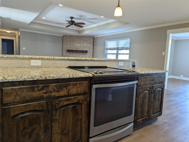 kitchen featuring dark brown cabinets, light wood-type flooring, a raised ceiling, and stainless steel electric range