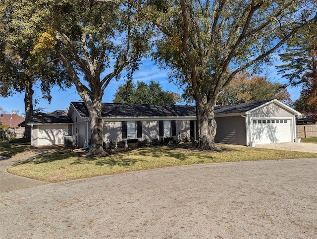 single story home featuring a front yard and a garage