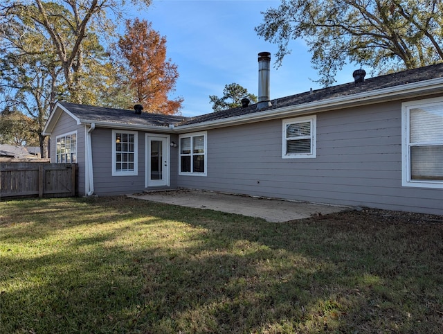 rear view of property featuring a patio area and a yard