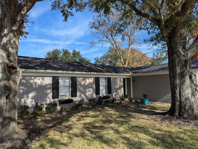 ranch-style home featuring a front lawn