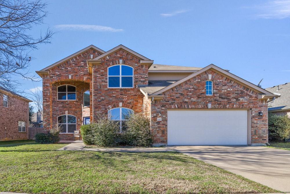 front facade with a garage and a front yard