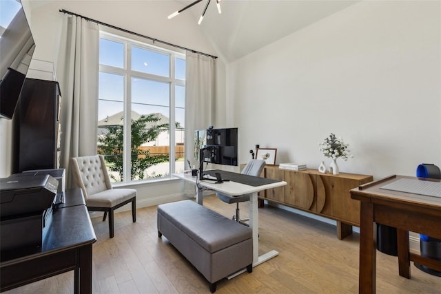 office with a notable chandelier, lofted ceiling, and light wood-type flooring