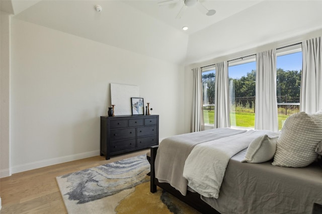 bedroom with light hardwood / wood-style flooring, ceiling fan, and lofted ceiling