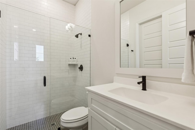 bathroom featuring vanity, an enclosed shower, and toilet