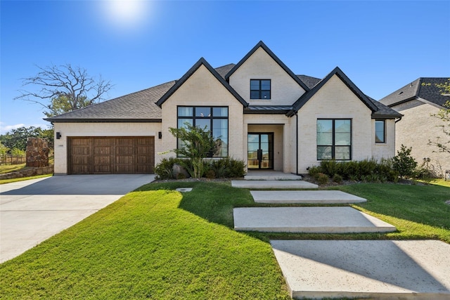 view of front facade with a garage and a front lawn