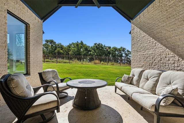 view of patio with an outdoor living space with a fire pit