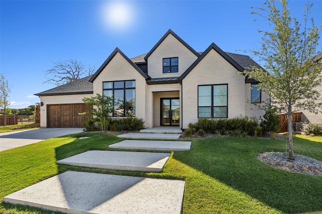 view of front of property featuring a front yard and a garage