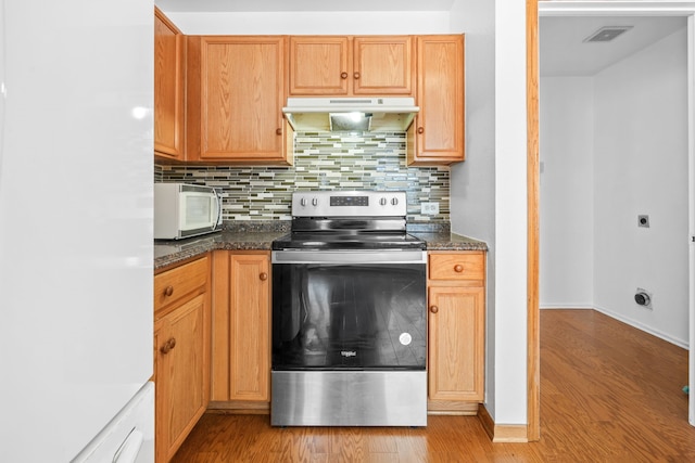 kitchen with decorative backsplash, dark stone countertops, stainless steel range with electric cooktop, and light hardwood / wood-style flooring