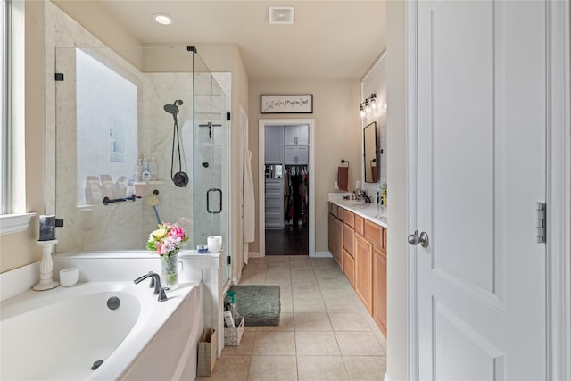 bathroom with tile patterned floors, vanity, and independent shower and bath