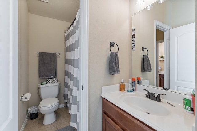 bathroom featuring tile patterned flooring, vanity, and toilet