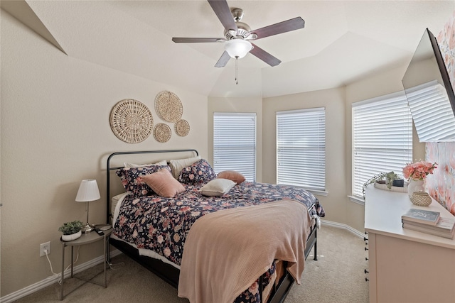 carpeted bedroom with vaulted ceiling and ceiling fan