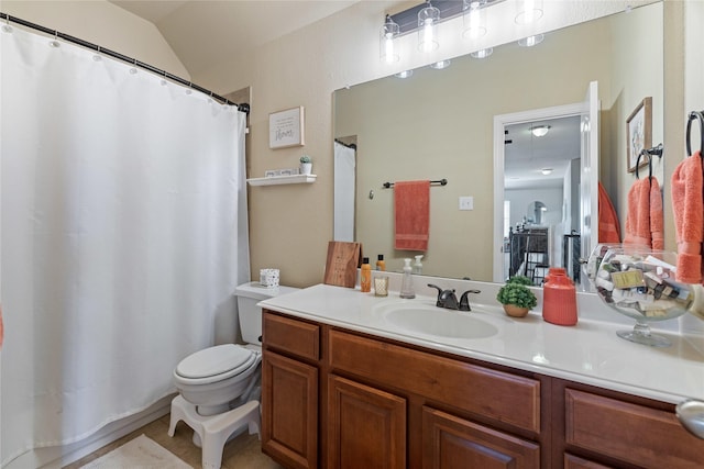 bathroom with vanity, vaulted ceiling, and toilet