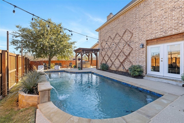 view of pool with a pergola, pool water feature, and french doors