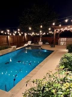 view of pool at night