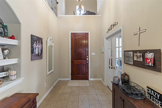 foyer featuring a high ceiling and light tile patterned floors