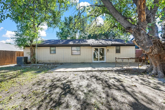 rear view of house with central AC unit and a patio area