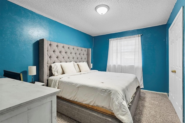 carpeted bedroom featuring a textured ceiling