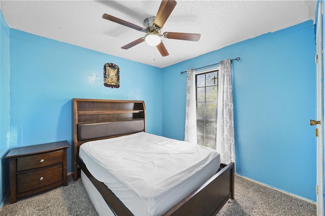 bedroom featuring ceiling fan, light carpet, and a textured ceiling