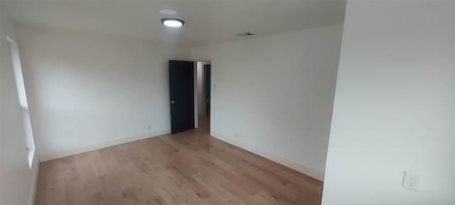 unfurnished room with light hardwood / wood-style flooring