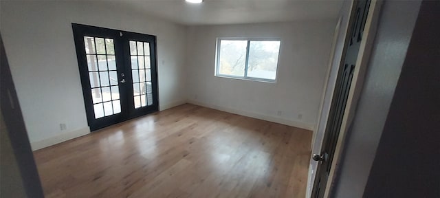 interior space with light hardwood / wood-style floors and french doors