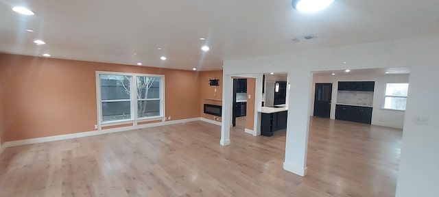 unfurnished living room with wood-type flooring