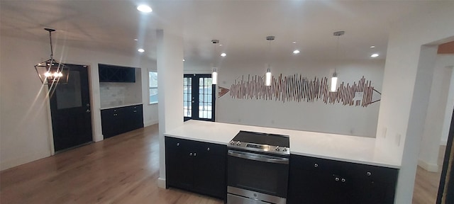 kitchen with an inviting chandelier, light wood-type flooring, and decorative light fixtures