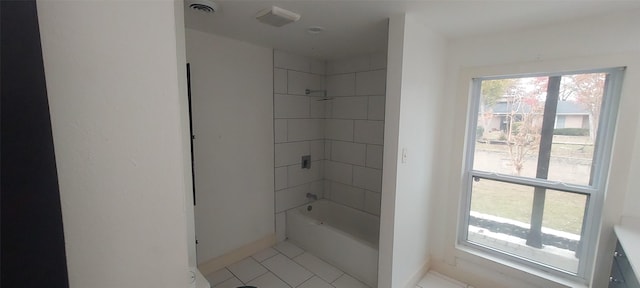 bathroom featuring tiled shower / bath combo and tile patterned floors