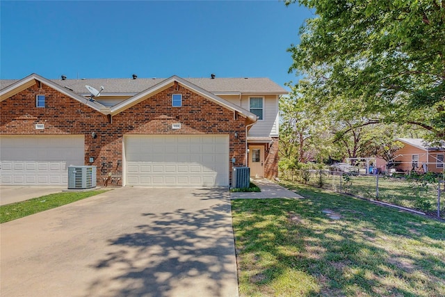 view of front of home featuring a garage and central AC unit