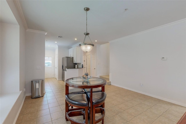 dining room featuring light tile patterned floors and ornamental molding