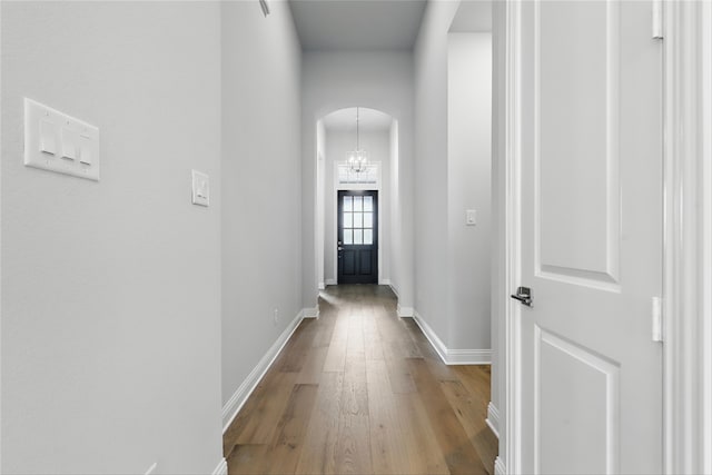 6300 Whitebrush Pl, Fort Worth, TX 76123 - corridor with arched walkways, wood finished floors, baseboards, and a chandelier