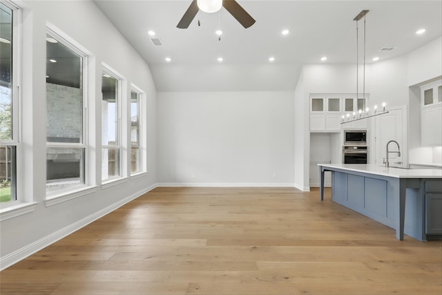 6300 Whitebrush Pl, Fort Worth, TX 76123 - kitchen featuring stainless steel appliances, white cabinetry, light countertops, ceiling fan, and glass insert cabinets