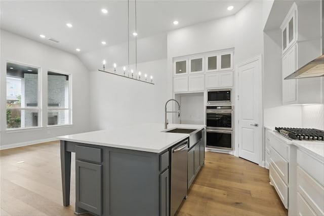 6300 Whitebrush Pl, Fort Worth, TX 76123 - kitchen featuring gray cabinetry, a sink, appliances with stainless steel finishes, wall chimney range hood, and white cabinetry