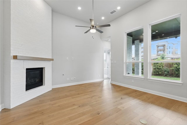 6300 Whitebrush Pl, Fort Worth, TX 76123 - unfurnished living room with light wood finished floors, a fireplace, a ceiling fan, baseboards, and recessed lighting
